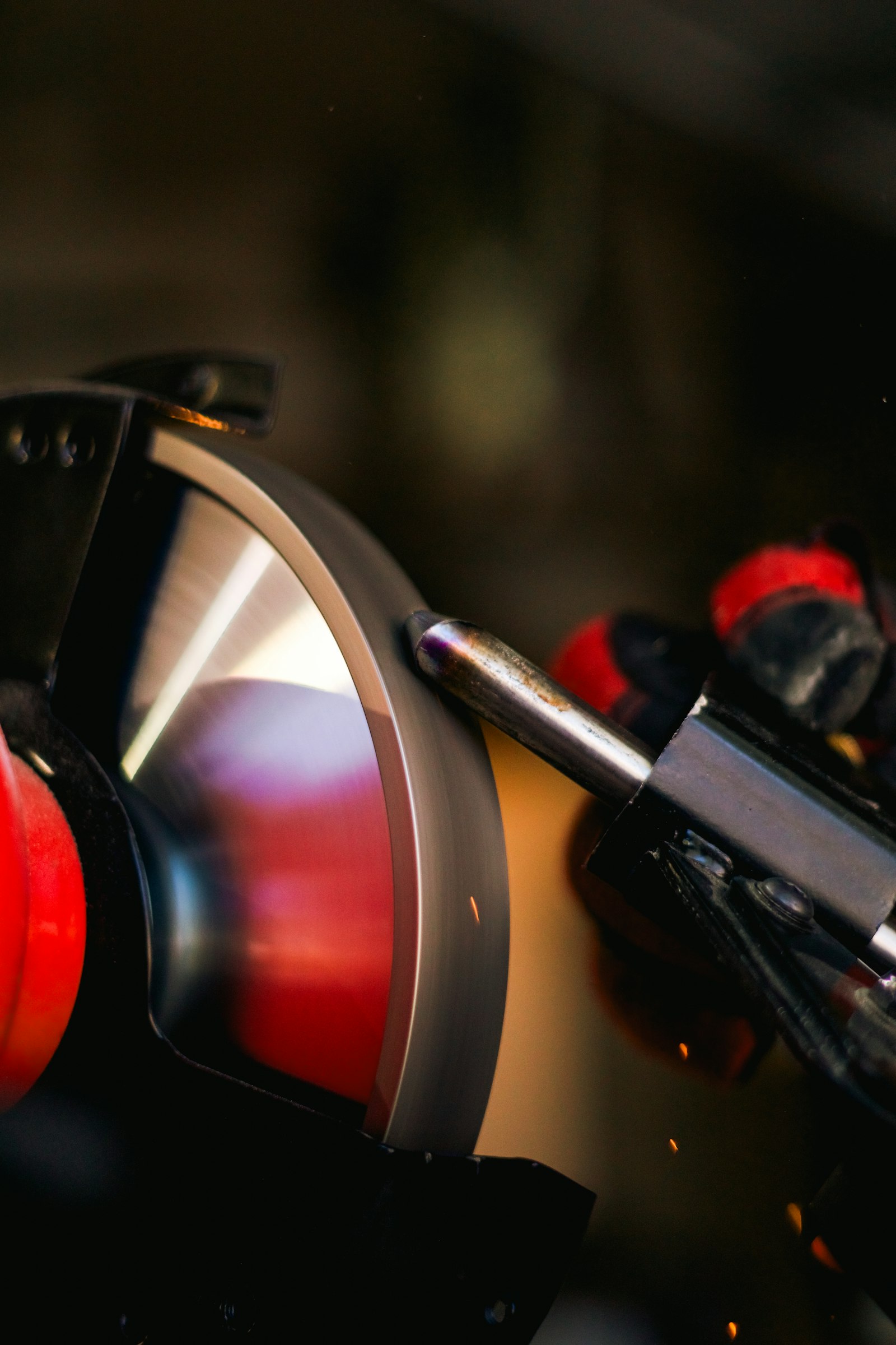 Tool being sharpened on a grinding wheel
